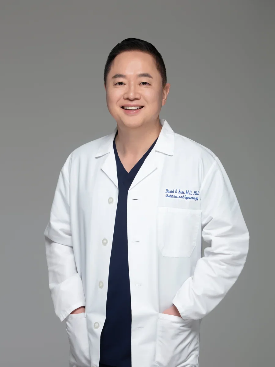 Dr. David Seil Kim, MD, PhD, FACOG, board-certified OB-GYN, in a white coat at Yunella Women's Health in Los Angeles